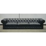 A LARGE STUDDED BLACK LEATHER UPHOLSTERED CHESTERFIELD SOFA