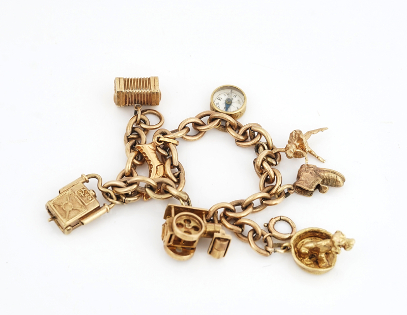 A 9CT GOLD CHARM BRACELET