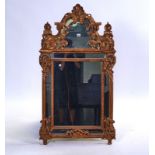 A MODERN GILT FRAMED WALL MIRROR