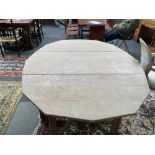 PROBABLY ‘AMBROSE HEAL’; AN EARLY 20TH CENTURY LIMED OAK DROP FLAP TABLE