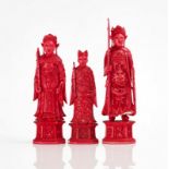 THREE CHINESE RED STAINED IVORY CARVED CHESS PIECES