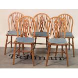 A set of five modern beech and elm wheelback dining chairs