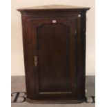 A late 18th century oak hanging corner cupboard