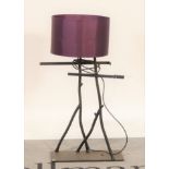 A modern black painted wrought iron table lamp