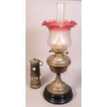 A Victorian brass oil lamp, with a coloured etched glass shade and an Ashington Colliery lamp