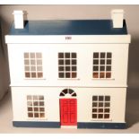 Circa 1970s a painted beech dolls house in the style of a Georgian house and a group of dolls...