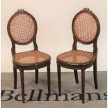 A pair of Louis XVI style stained beech and cane work side chairs
