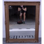 A modern gilt framed rectangular wall mirror