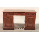 A Victorian mahogany inverted break front pedestal desk