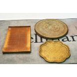 Two 20th century Eastern brass trays and a shove hapenny board.