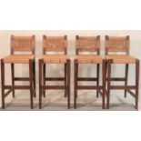 A set of four modern oak and rope bar stools