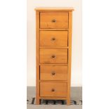 A modern oak tall chest of five short drawers