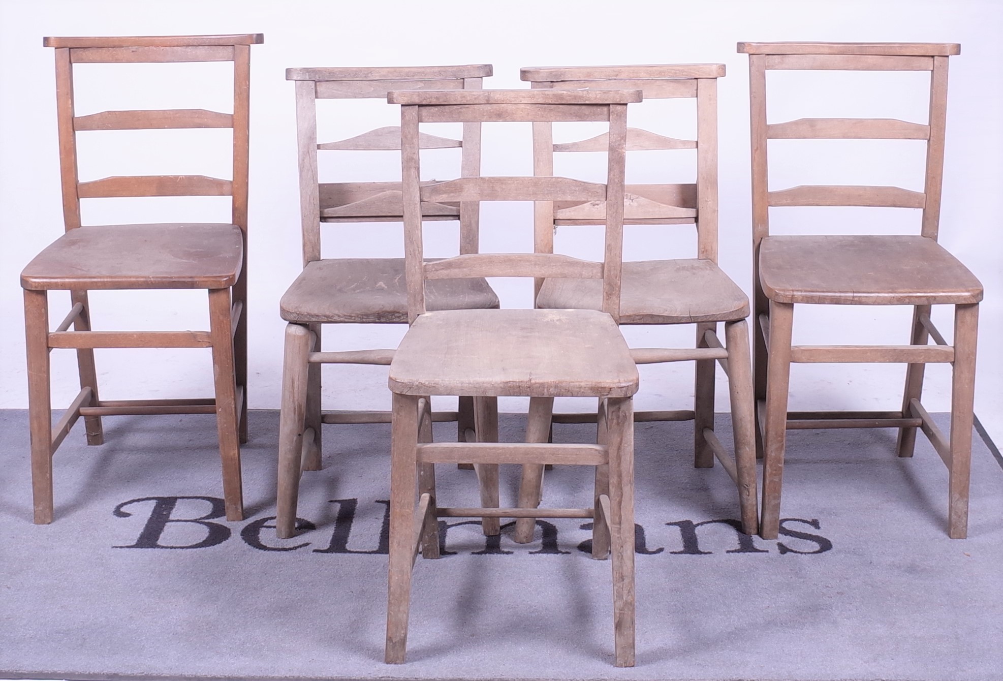 A matched set of five early 20th century beech and elm chapel chairs