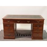 An early 20th century walnut pedestal desk