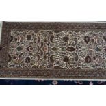 A machine made floral runner of Persian design