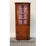 A late George III oak floor standing corner display cabinet