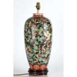 A Chinese porcelain black-ground famille-rose vase adapted as lamp