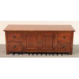 A modern oak low sideboard cupboard doors flanked by four short drawers