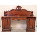 A Victorian mahogany inverted breakfront pedestal sideboard