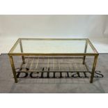 An early 20th century brass and glass rectangular coffee table