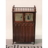 An Edwardian rosewood music cabinet