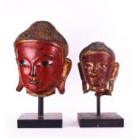 A SOUTH-EAST ASIAN CINNABAR LACQUER BUDDHA HEAD OF LARGE SIZE TOGETHER WITH ANOTHER
