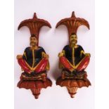 A PAIR OF CHINESE POLYCHROME DECORATED FIGURATIVE WALL MOUNTS (2)