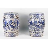 A PAIR OF CHINESE STYLE BLUE AND WHITE GLAZED CERAMIC BARREL SHAPED GARDEN SEATS (2)