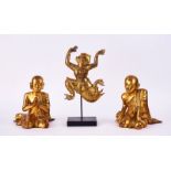 A PAIR OF SOUTH-EAST ASIAN GILTWOOD FIGURES OF KNEELING MONKS TOGETHER WITH A DANCING FIGURE (3)