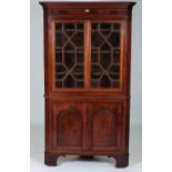 A LATE GEORGE III MAHOGANY FLOORSTANDING CORNER DISPLAY CABINET