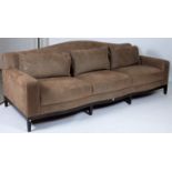 A MODERN HARDWOOD FRAMED THREE SEATER HUMPBACK SOFA