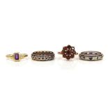 A 9CT GOLD AND GARNET CLUSTER RING AND THREE FURTHER RINGS