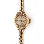 AN ACCURIST 9CT GOLD LADY'S BRACELET WRISTWATCH