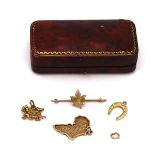 THREE GOLD CHARMS AND A GOLD BROOCH (4)