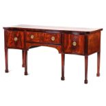 A GEORGE III SERPENTINE MAHOGANY SIDEBOARD