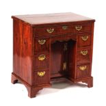 A GEORGE II WALNUT KNEEHOLE WRITING DESK