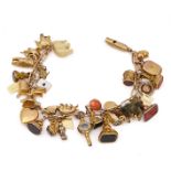 A GOLD BRACELET, FITTED WITH THIRTY-SIX PENDANTS AND CHARMS