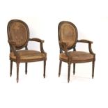 A PAIR OF LOUIS XVI STYLE GREEN PAINTED OPEN ARMCHAIRS (2)