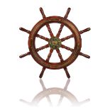 A BRASS-BOUND TEAK SHIP'S WHEEL