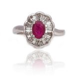 AN 18CT WHITE GOLD, RUBY AND DIAMOND SHAPED OVAL CLUSTER RING