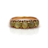 A GOLD AND CHRYSOBERYL CAT'S EYE FIVE-STONE RING