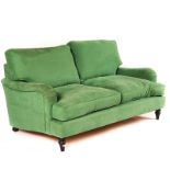 A MODERN GREEN UPHOLSTERED TWO SEAT SOFA