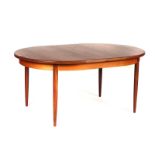 G-PLAN; A TEAK OVAL EXTENDING DINING TABLE