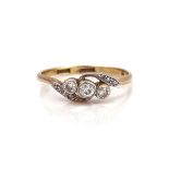 A 14CT GOLD AND DIAMOND THREE STONE RING