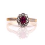 A GOLD, RUBY AND DIAMOND OVAL CLUSTER RING