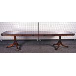 A GEORGE III STYLE MAHOGANY EXTENDING DINING TABLE