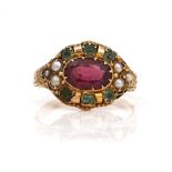 A VICTORIAN 15CT GOLD, GARNET AND GEM SET OVAL CLUSTER RING