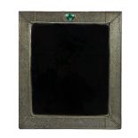 IN THE MANNER OF LIBERTY’S; A BEATEN PEWTER AND SEMI-PRECIOUS STONE INSET STRUT MIRROR