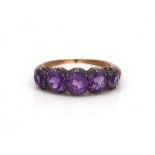 A GOLD AND SILVER SET AMETHYST FIVE STONE RING