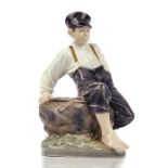 `BOY ON ROCK' A LARGE ROYAL COPENHAGEN FIGURE